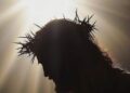 Silhouette of Jesus Christ with crown of thorns and radiant light symbolizing His sacrifice and resurrection, representing the true meaning of Easter in 2025